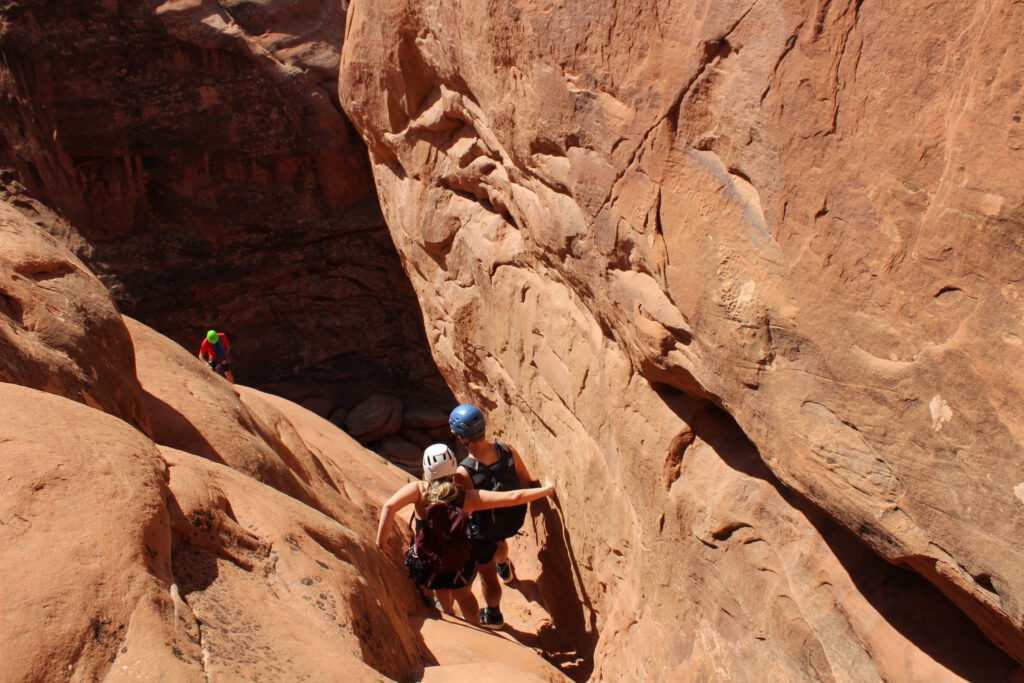 a couple bouldering in a canyon